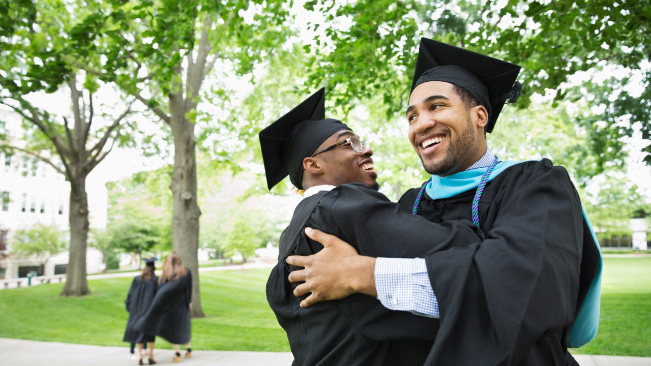 Two college graduates embrace