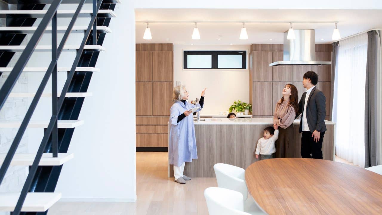 Three people looking around a house