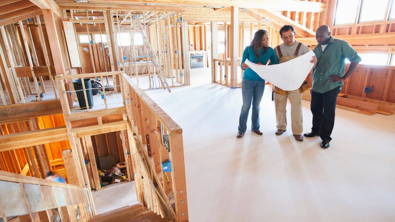 Contractor looking at plans with homeowners