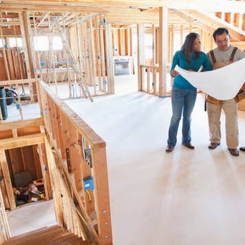 Contractor looking at plans with homeowners