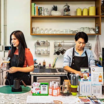 Female owners are working on small business cafe.