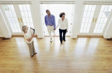 Real estate agent walking into a home with a couple