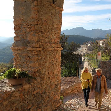 She checks smart phone for direction. Mountains in distance