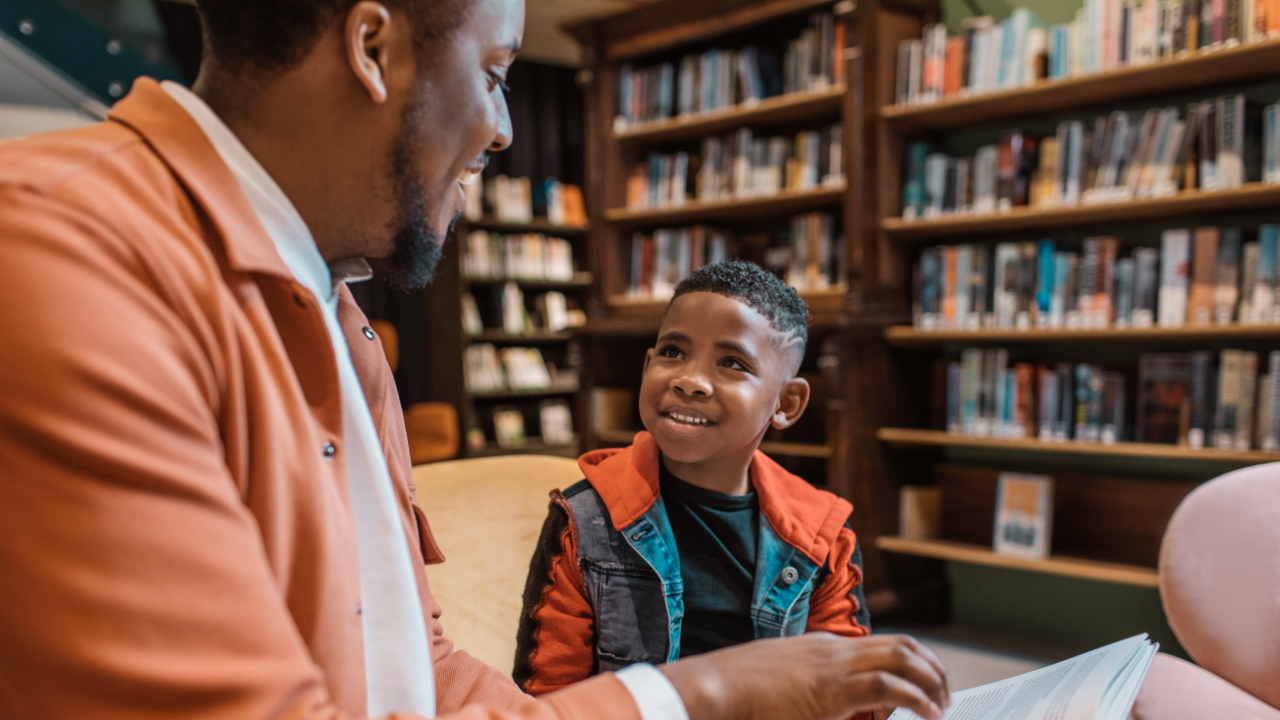 A group of young black and diverse school children in a dutch library