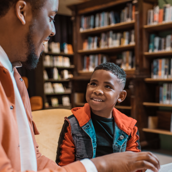 A group of young black and diverse school children in a dutch library