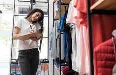 Multitasking woman working at clothing store