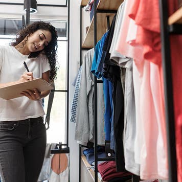 Multitasking woman working at clothing store