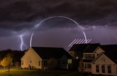 Storm clouds and lightning over a small neighborhood