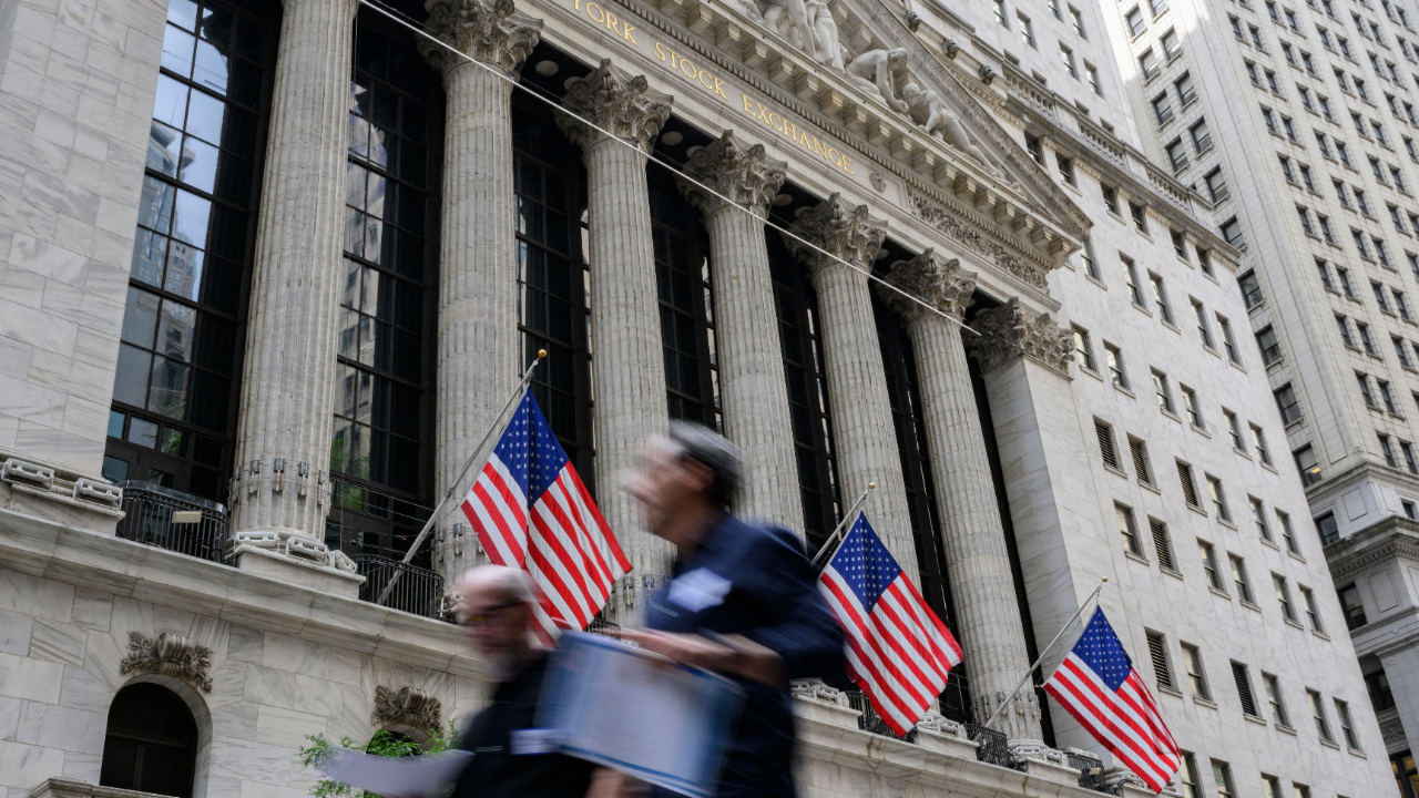 People walk past the New York Stock Exchange