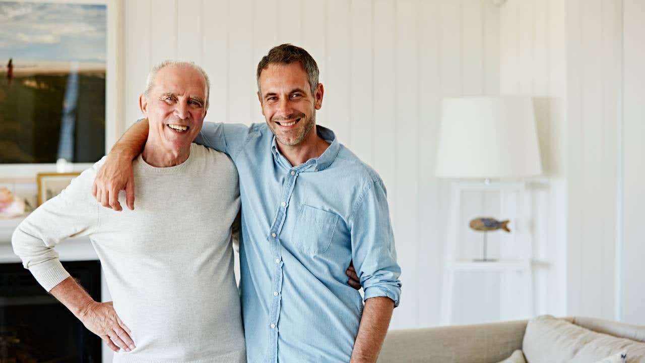 adult son with arm around elderly dad