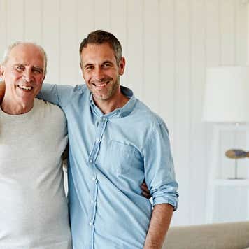 adult son with arm around elderly dad