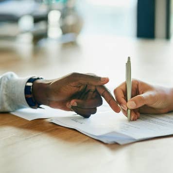 Person assisting another person with signature