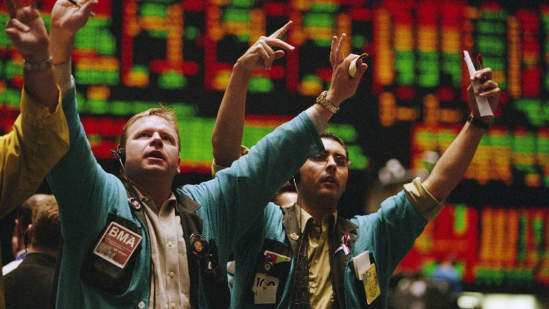 traders waving arms on the exchange floor