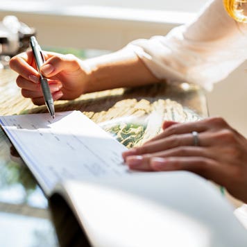 person signing a check