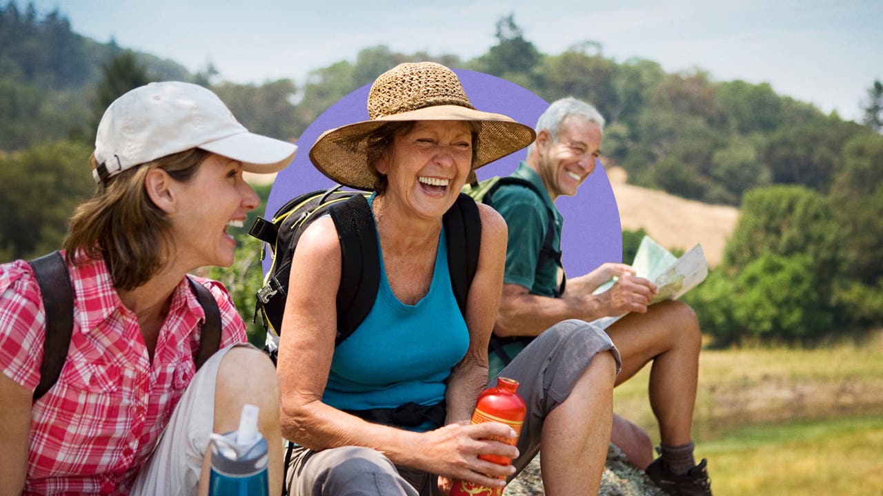 Three happy hikers taking a water break