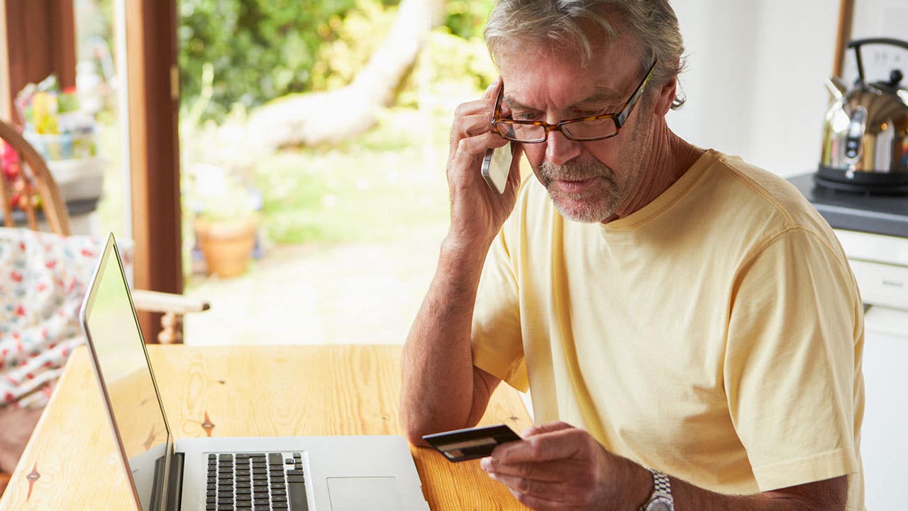 Mature Man Making On Line Purchase Using Credit Card