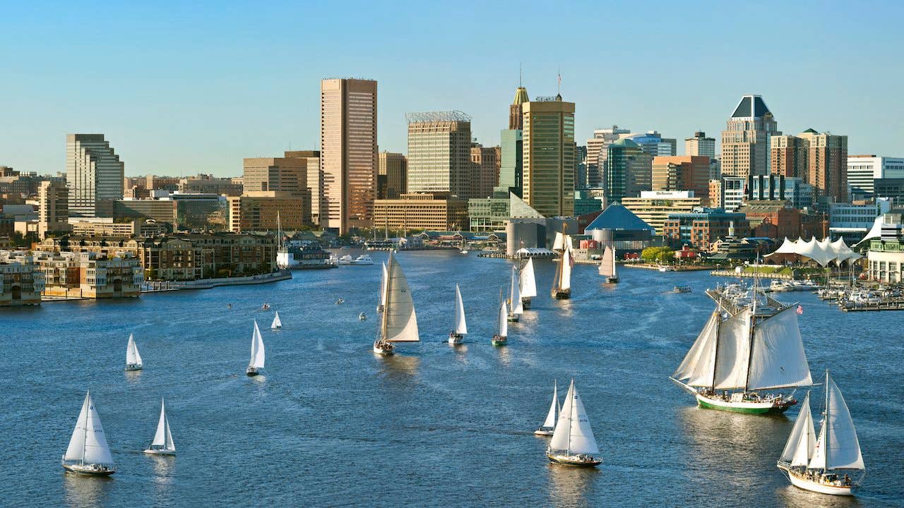 Sailboats in the Chesapeake Bay at Baltimore, Maryland's Inner Harbor, with city skyline