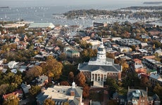 Aerial view of Annapolis, Maryland, including the historic state capitol building and sailboats in the harbor