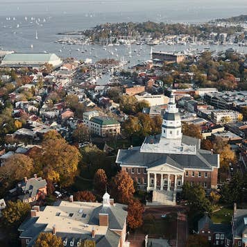 Aerial view of Annapolis, Maryland, including the historic state capitol building and sailboats in the harbor