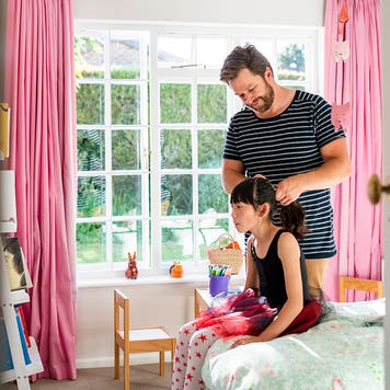 father doing daughters hair