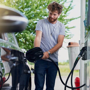 man pumping gas at a gas station