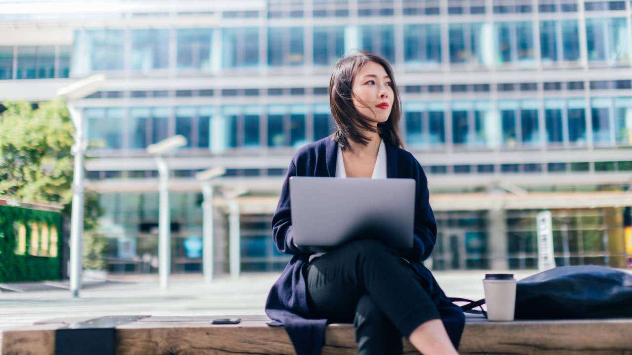 Confident Businesswoman Working With Laptop In The Financial District