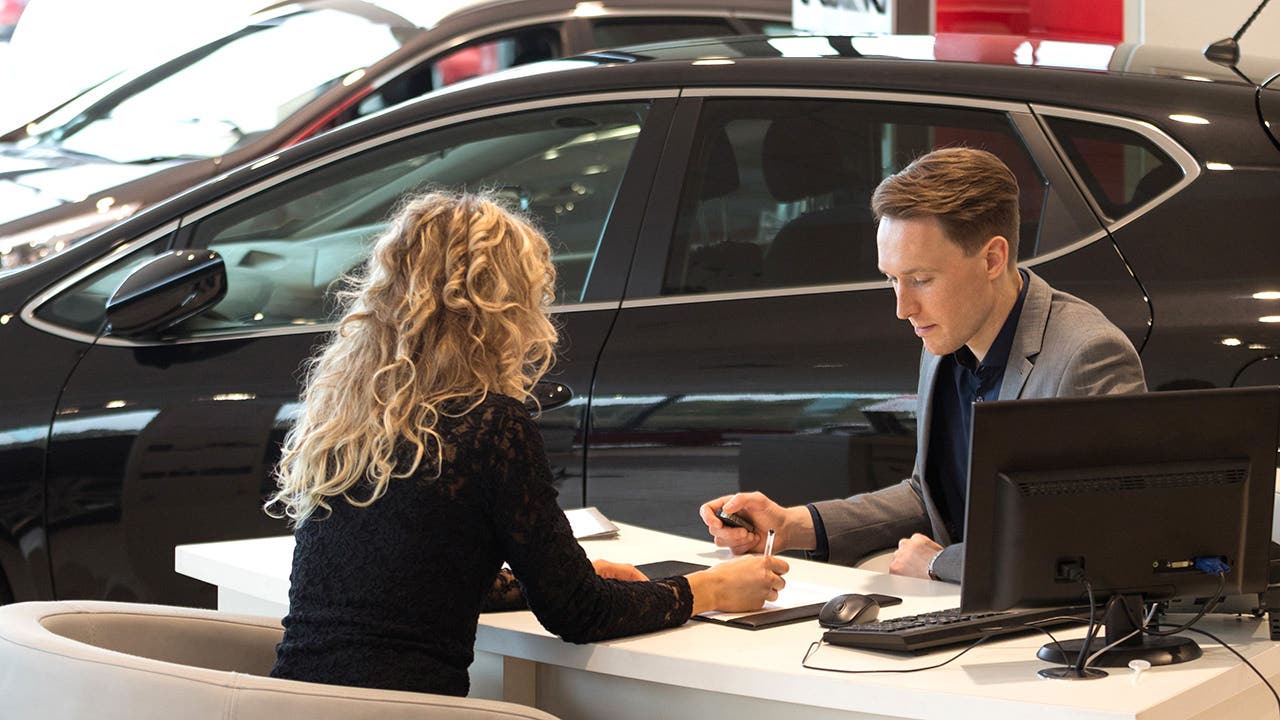 female customer in car dealership