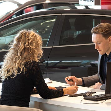 female customer in car dealership
