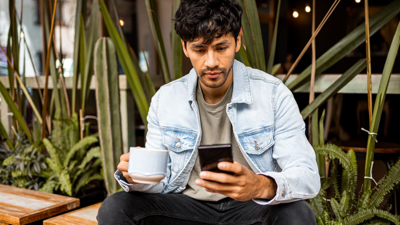 Man sitting outside on smartphone