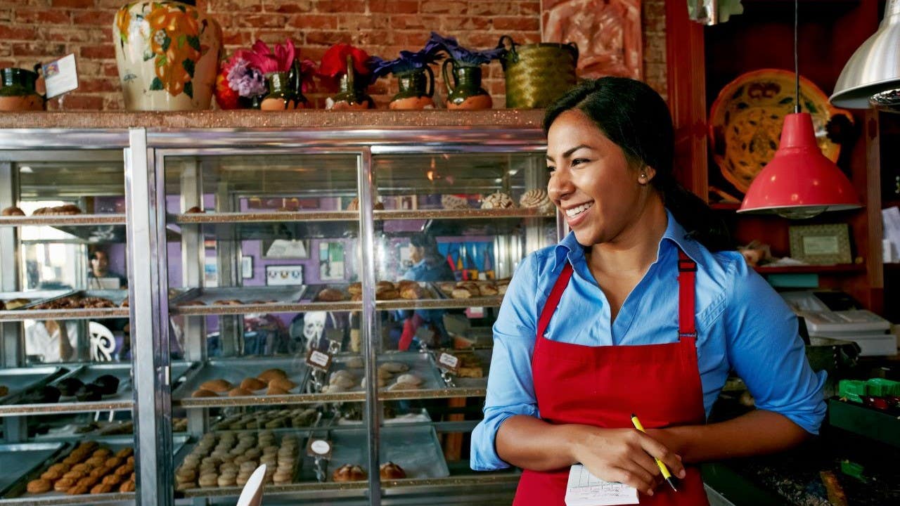 Woman taking orders in a bakery