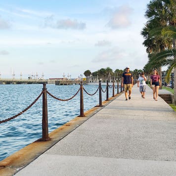 family walking on a path by the water in Florida