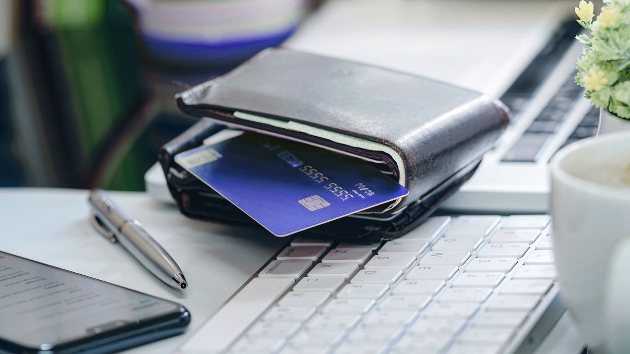 credit card in a wallet sitting on a desk