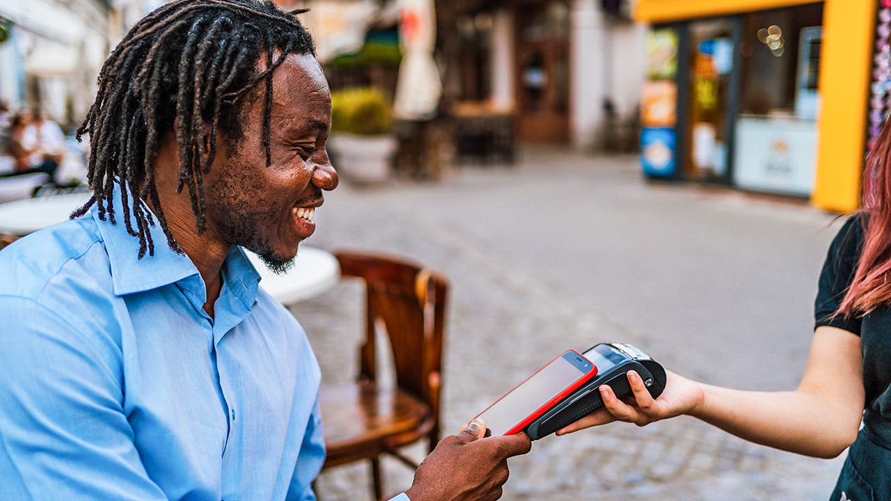 Man paying courier via smartphone