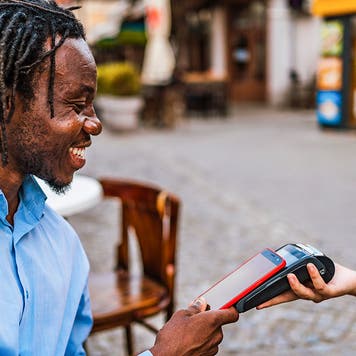 Man paying courier via smartphone