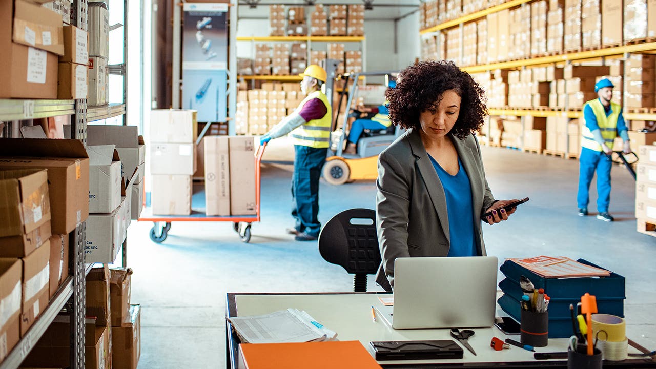 Warehouse Manager using a laptop