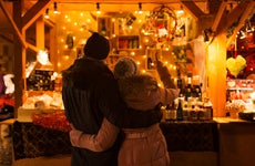 a couple looking at items at a Christmas market