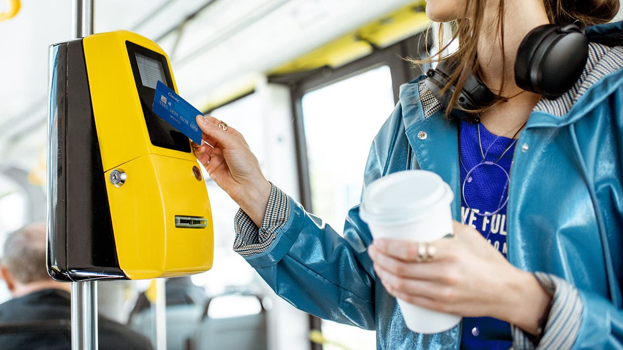 Woman paying with card for the public tarnsport