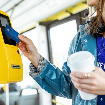 Woman paying with card for the public tarnsport