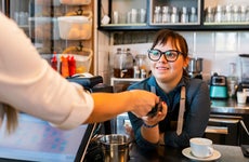 a person checking out with a barista