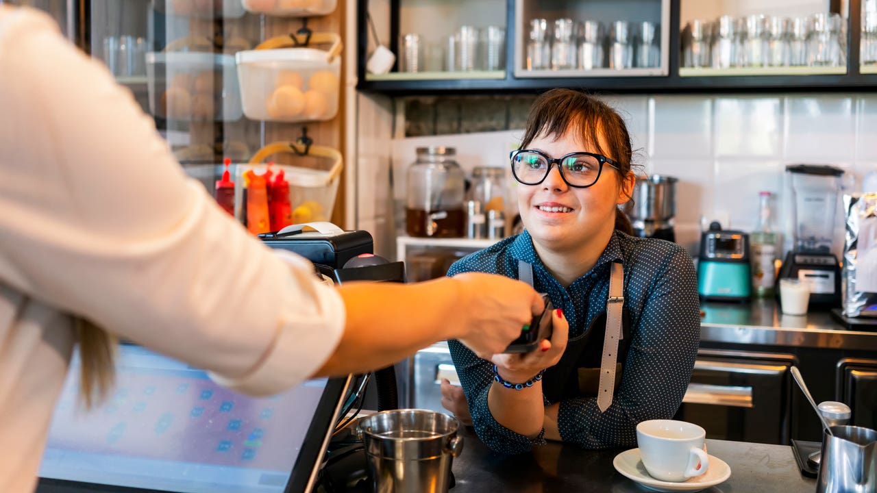 a person checking out with a barista
