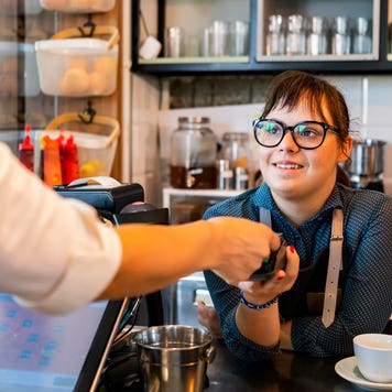 a person checking out with a barista