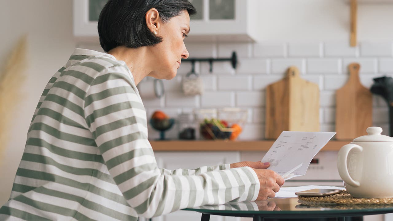 woman looking at a bill