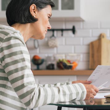 woman looking at a bill