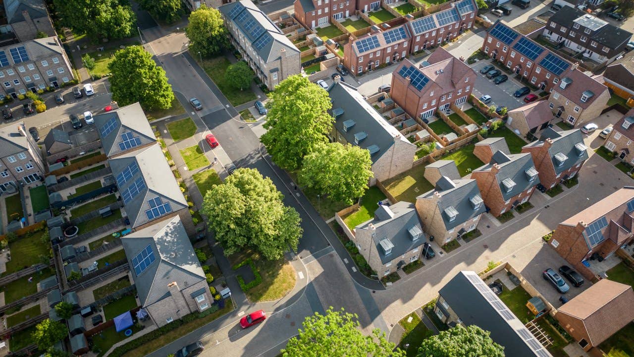 Aerial view of a modern housing development with solar panels installed on all the rooftops