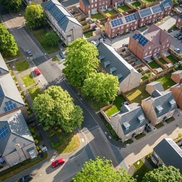Aerial view of a modern housing development with solar panels installed on all the rooftops