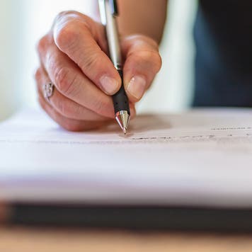 signing a piece of paper
