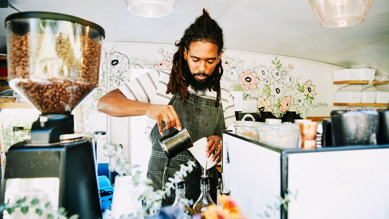 barista pouring coffee