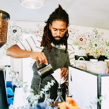 barista pouring coffee