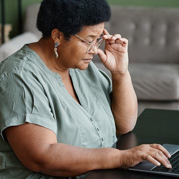Black Senior Woman Using Laptop