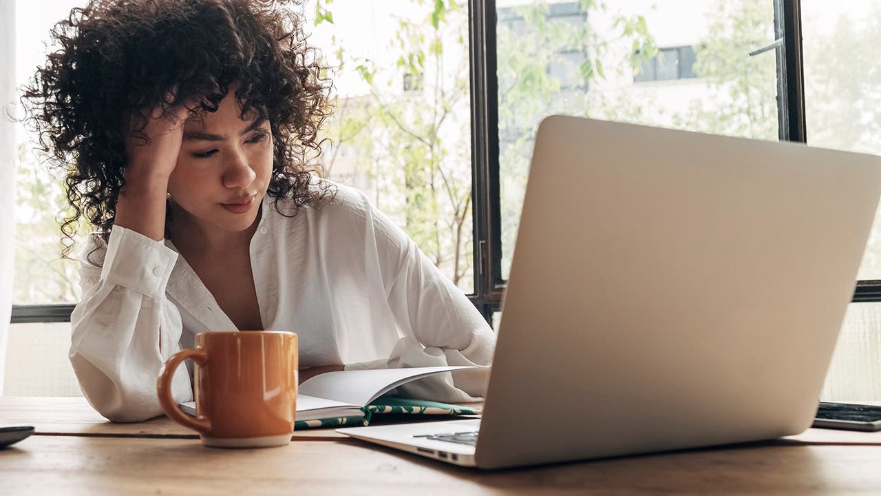 woman looking tired at computer